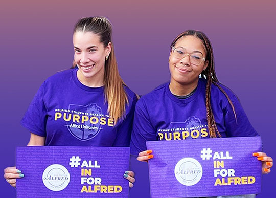 two young women holding signs