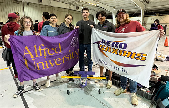 group of students holding two banners