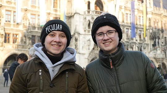 two young women in front of a building