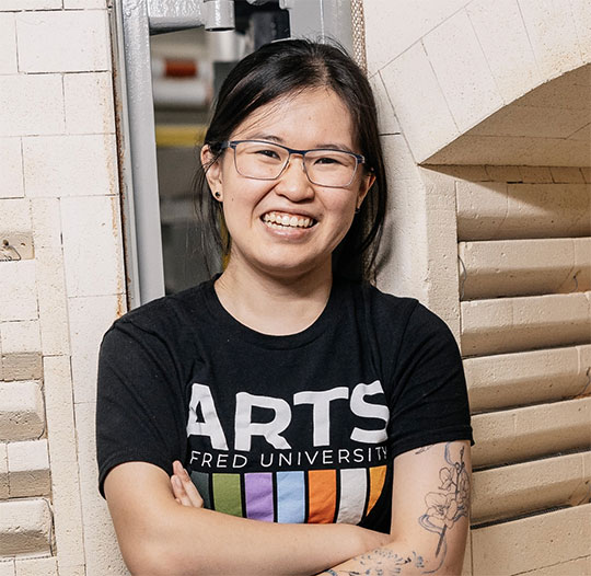 headshot of woman with glasses smiling