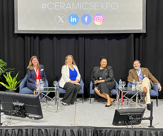 four people, three women and a man, sitting in chairs