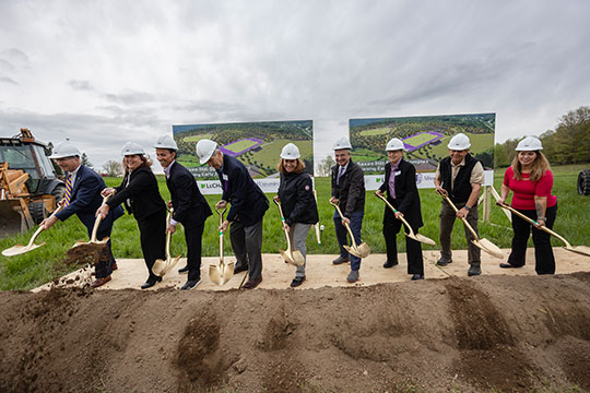 group of people shoveling dirt