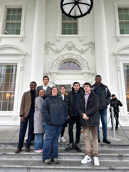 group of people standing in front of building