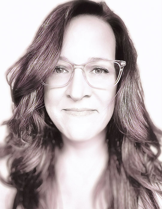 headshot of woman with long dark hair and glasses