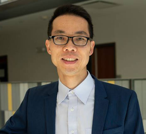 headshot of man with sport coat and glasses
