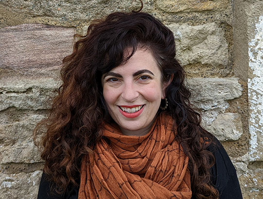 woman with long dark hair and scarf
