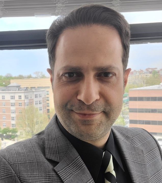 man in suit and tie, smiling