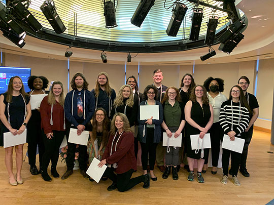 group of people holding certificates