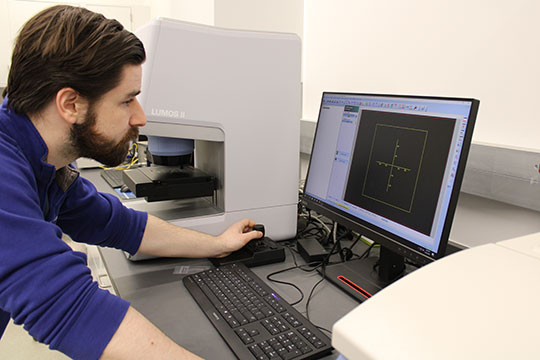 man with beard, looking at computer