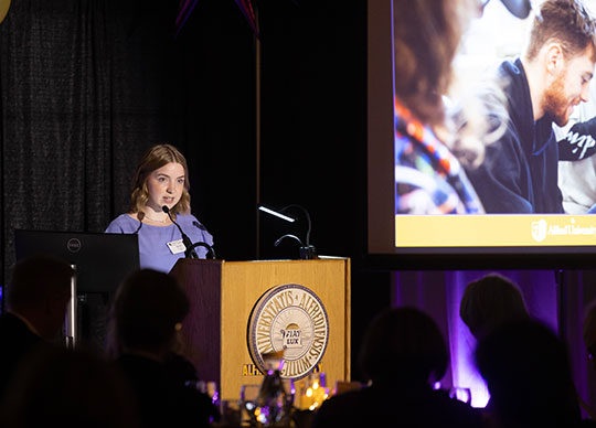 young woman speaking at a podium