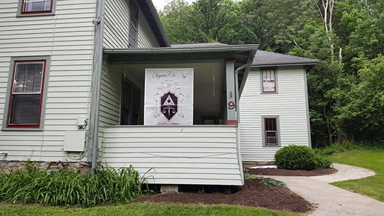 white house with banner on porch