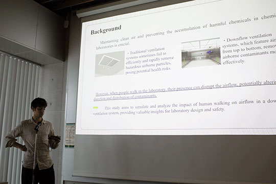 young man standing in front of screen giving presentation