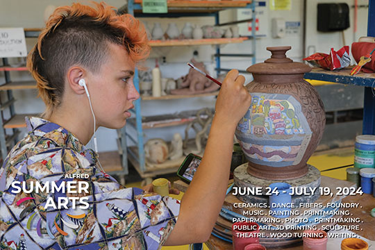 person painting pottery