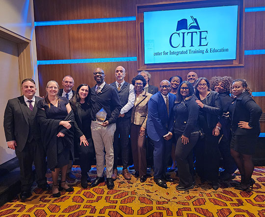 group of many people standing in rows smiling
