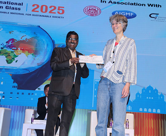 woman on stage getting a certificate from a man