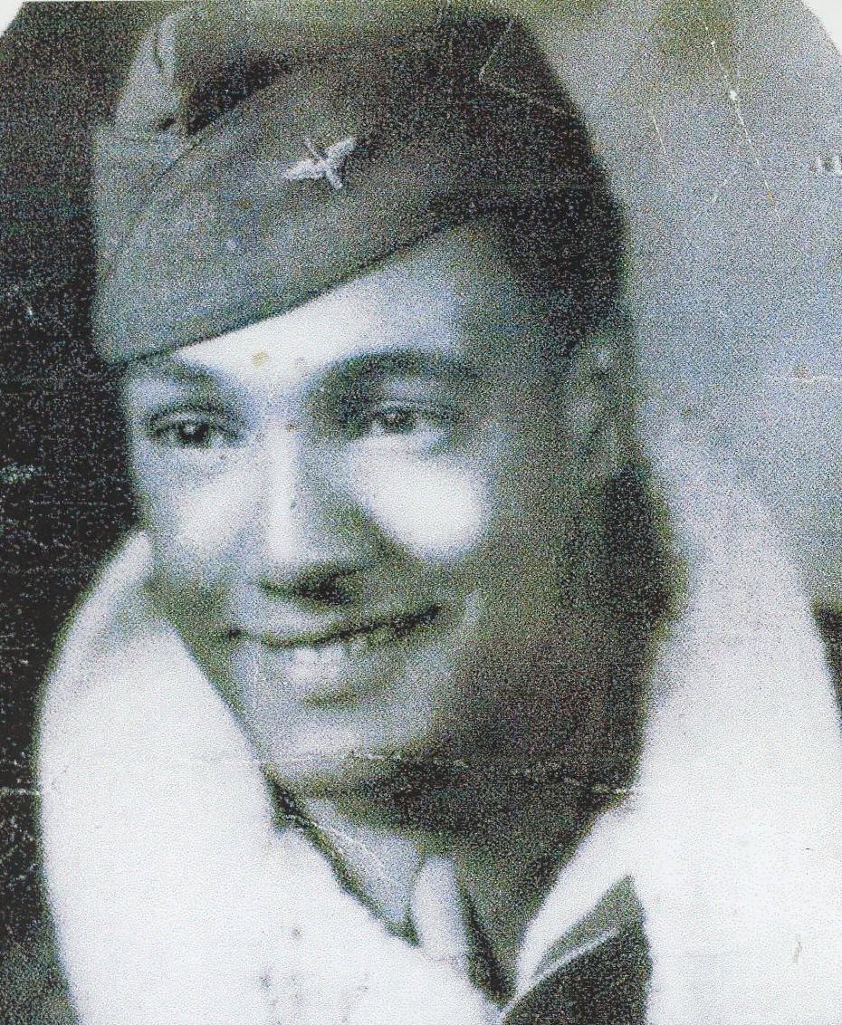Black and white portrait of a smiling man wearing a military cap and a fur-collared jacket, conveying a sense of warmth and nostalgia.