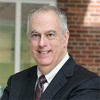 small headshot of John Simmins