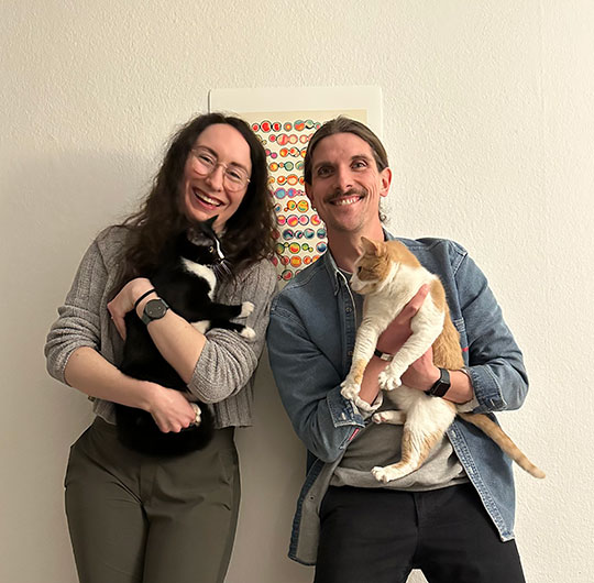 woman and man holding cats