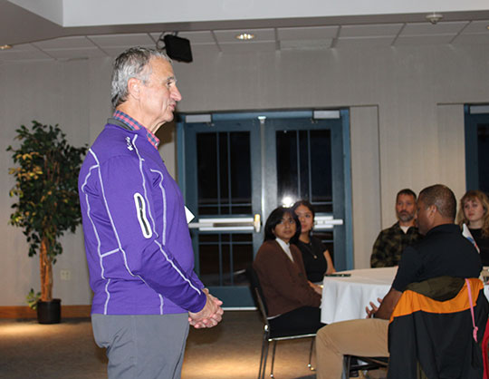 man standing and speaking to a group