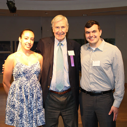 tall man stranding with a young woman and a young man