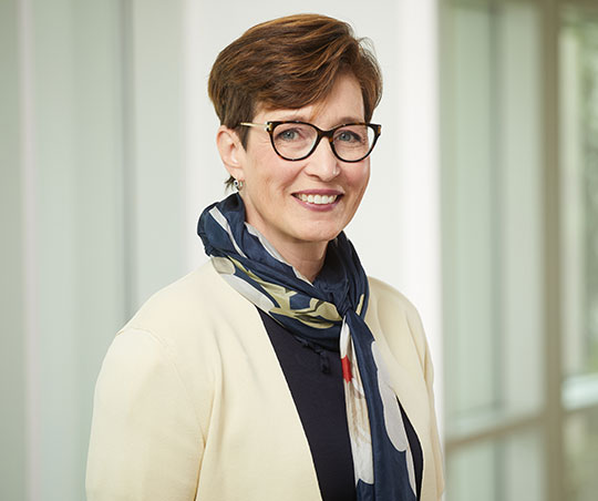 Headshot of woman with glasses smiling