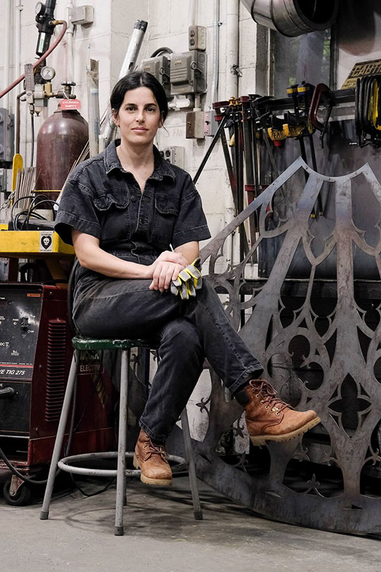 woman sitting on a stool in an art studio