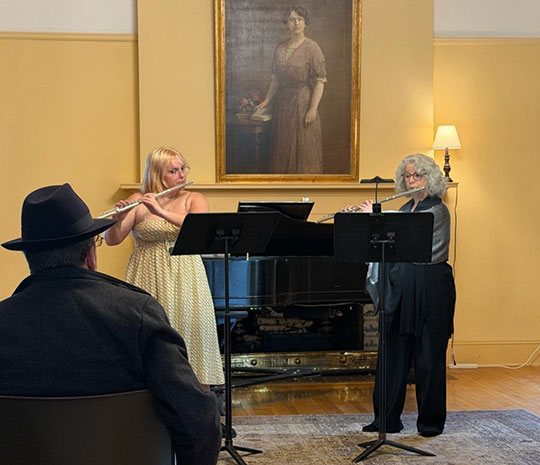 two people playing the flute