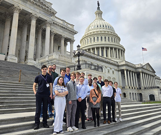 group of people standing on steps in front of a building