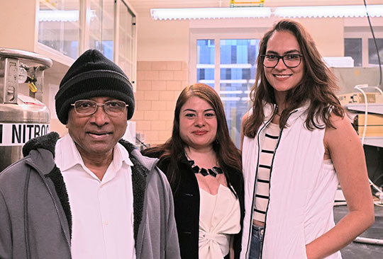 a man and two women, smiling at the camera