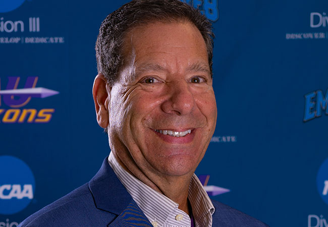 headshot of man in sport coat smiling