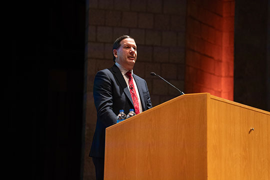 man talking at podium