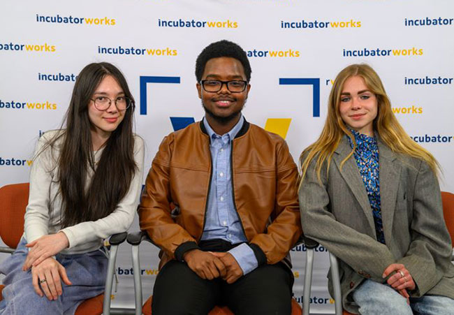 three people sitting in a row