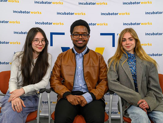 three people sitting in a row