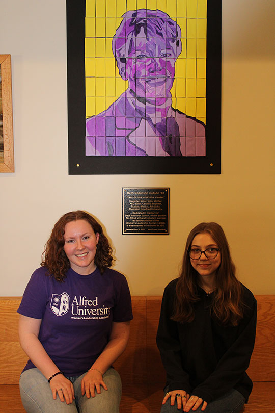 two wimen sitting next to each other on a bench