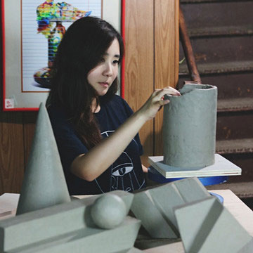 woman working on a ceramic pot