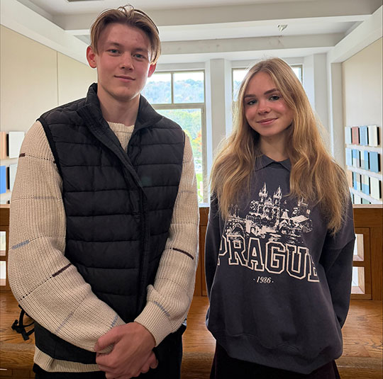 young man and young woman standing next to each other