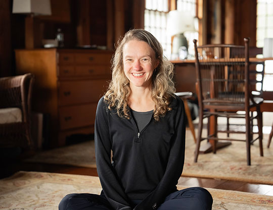 woman sitting on the floor, smiling