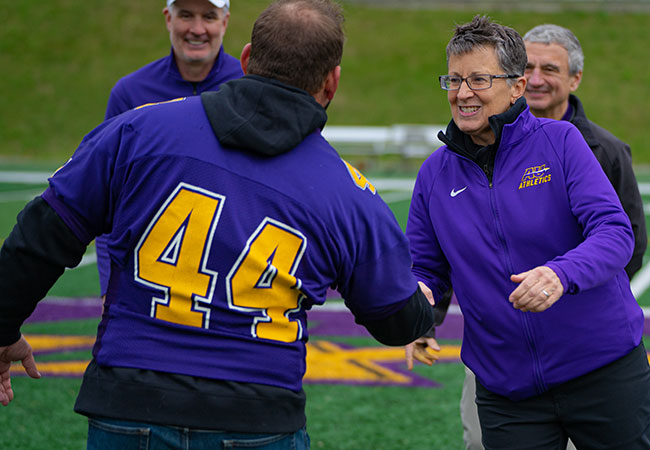 woman shaking a man's hand