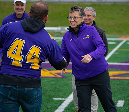 woman shaking a man's hand