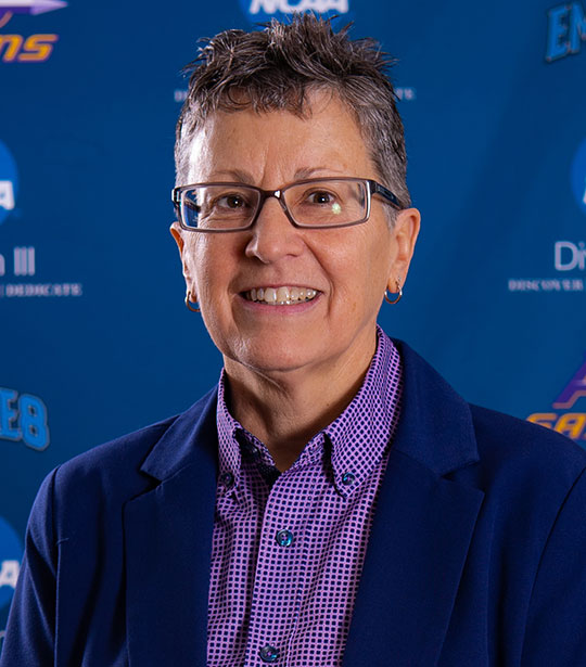 headshot of woman with short hair and glasses
