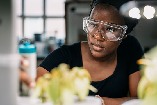 woman with goggles in a lab