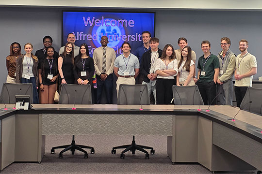 group of people standing in a conference room in front of a projection screen