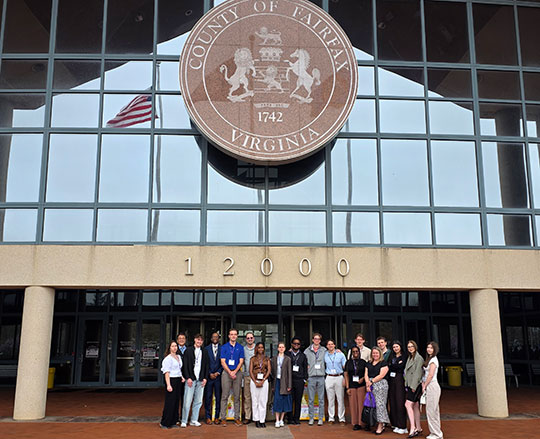 group of people standing in front of a building