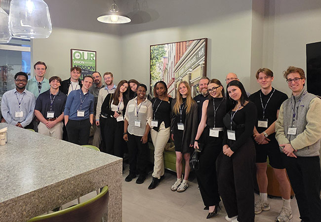 group of people standing in a row smiling