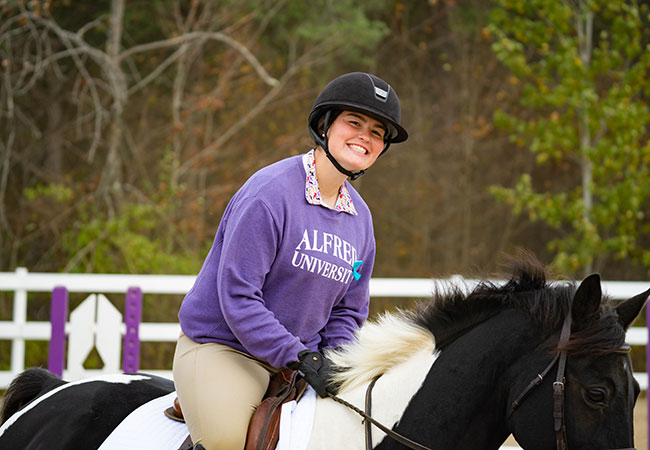 young woman riding a horse
