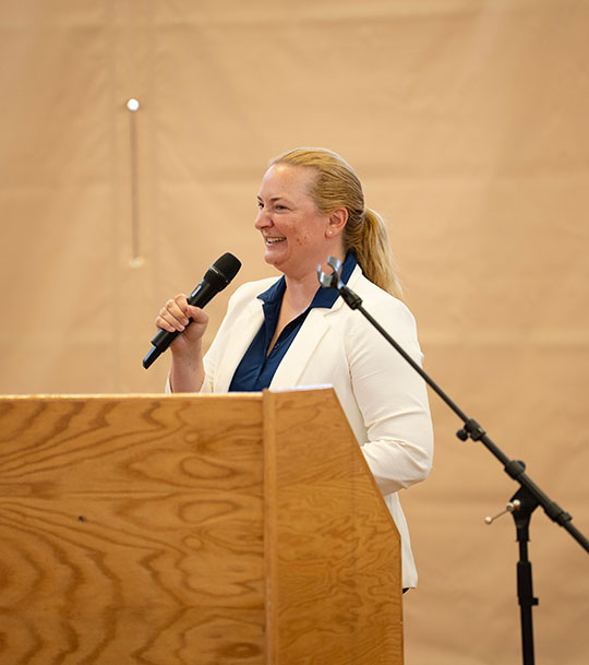 woman talking at a podium