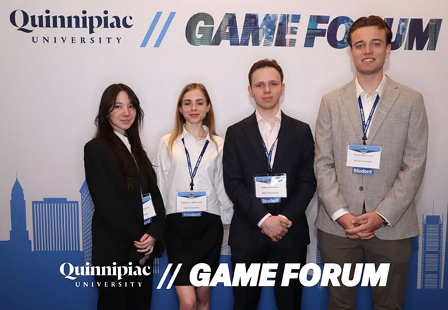 four young people standing in a row