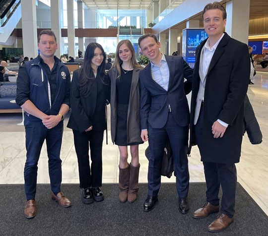 five people standing in a row