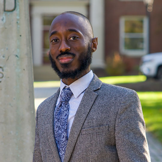 headshot of man in suit and tie