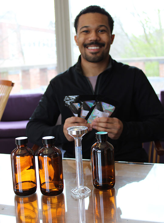 man standing with a display of bottles